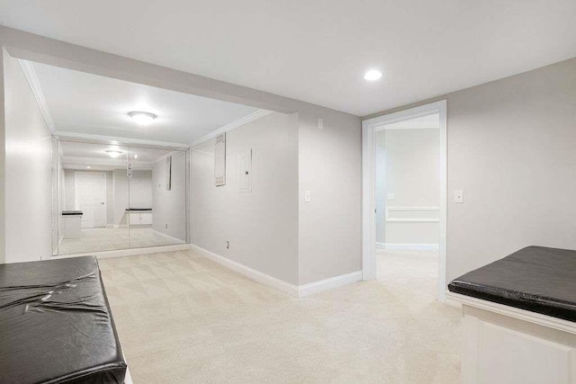 basement featuring crown molding and light colored carpet