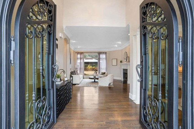 foyer entrance featuring dark hardwood / wood-style floors and ornamental molding