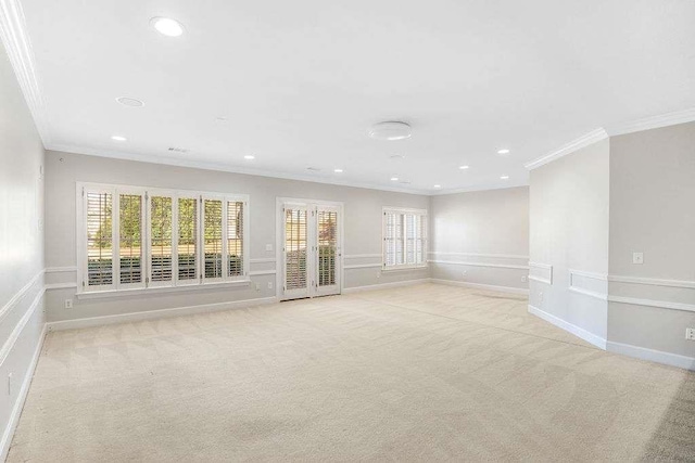 unfurnished room featuring light colored carpet and ornamental molding