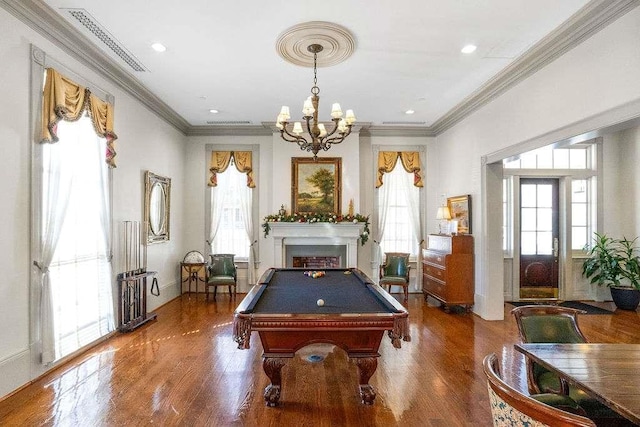 recreation room featuring ornamental molding, dark hardwood / wood-style flooring, a chandelier, and pool table