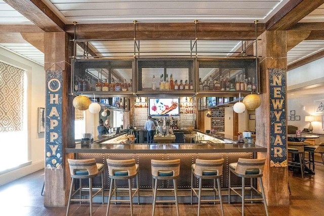 bar featuring beamed ceiling and dark wood-type flooring