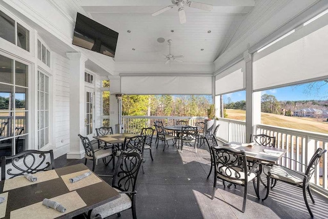 sunroom / solarium featuring ceiling fan and lofted ceiling