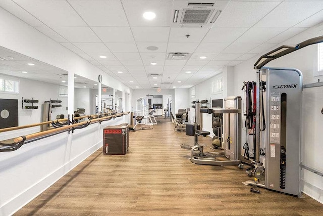 exercise room featuring a drop ceiling