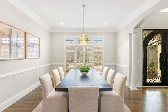 dining room featuring a chandelier, dark wood-type flooring, and ornamental molding