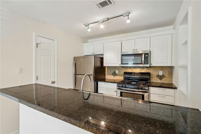 5638 River Heights Xing SE, Marietta, GA 30067 - kitchen featuring tasteful backsplash, visible vents, white cabinetry, and stainless steel appliances