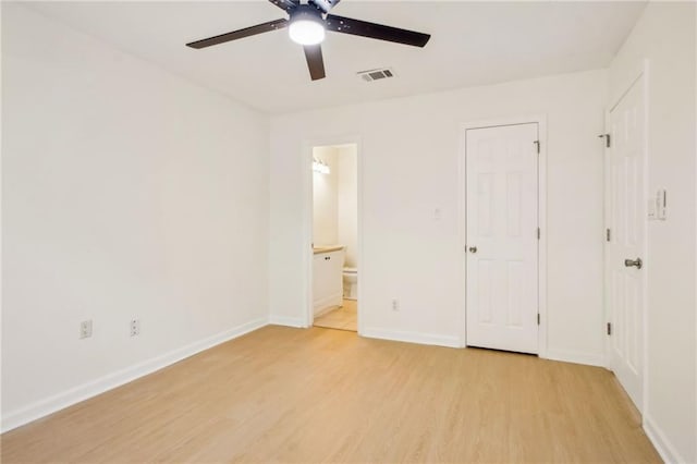 5638 River Heights Xing SE, Marietta, GA 30067 - unfurnished bedroom with baseboards, ensuite bathroom, light wood-style flooring, a ceiling fan, and visible vents