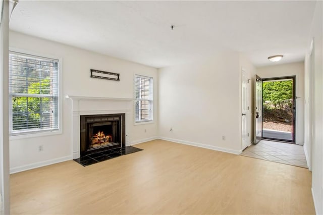 5638 River Heights Xing SE, Marietta, GA 30067 - unfurnished living room featuring a fireplace with flush hearth, baseboards, and wood finished floors