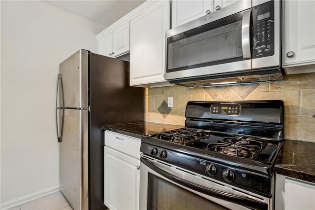 5638 River Heights Xing SE, Marietta, GA 30067 - kitchen featuring white cabinetry, decorative backsplash, dark stone counters, and appliances with stainless steel finishes
