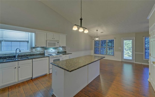 kitchen with dark wood-style floors, a sink, white appliances, a chandelier, and white cabinetry