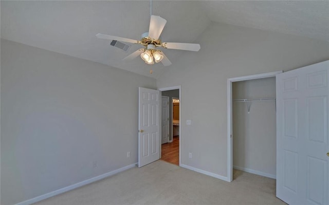 unfurnished bedroom featuring carpet, vaulted ceiling, visible vents, a closet, and baseboards