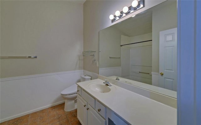 bathroom with toilet, vanity, and a shower