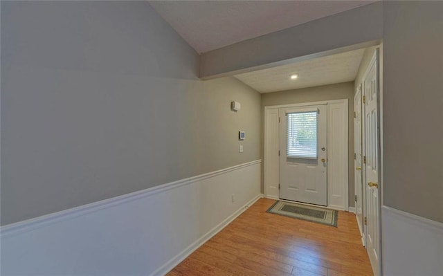 doorway to outside with baseboards and wood finished floors