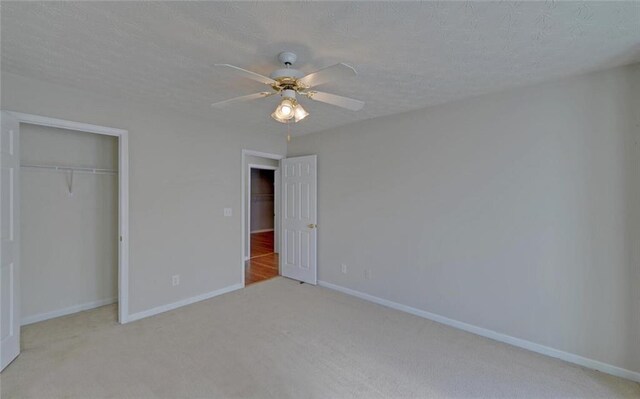 unfurnished bedroom with ceiling fan, baseboards, a closet, and carpet