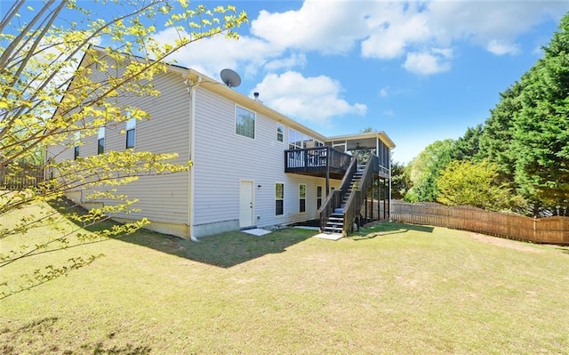 back of house featuring stairway, fence, a yard, and a deck