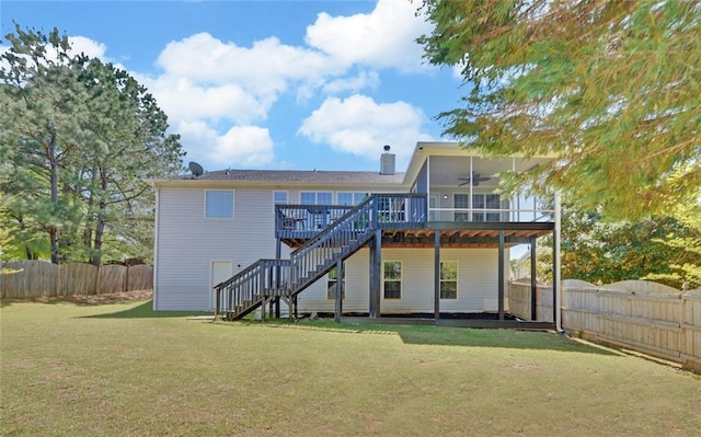 back of house featuring a ceiling fan, stairs, a deck, a yard, and a sunroom
