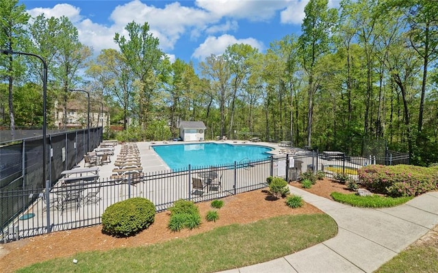 community pool with a patio and fence