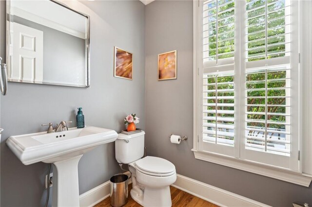 11259 Calypso Dr, Alpharetta, GA 30009 - half bath featuring baseboards, toilet, and healthy amount of natural light