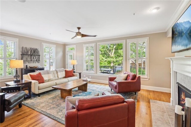 11259 Calypso Dr, Alpharetta, GA 30009 - living room with a high end fireplace, a ceiling fan, healthy amount of natural light, crown molding, and baseboards