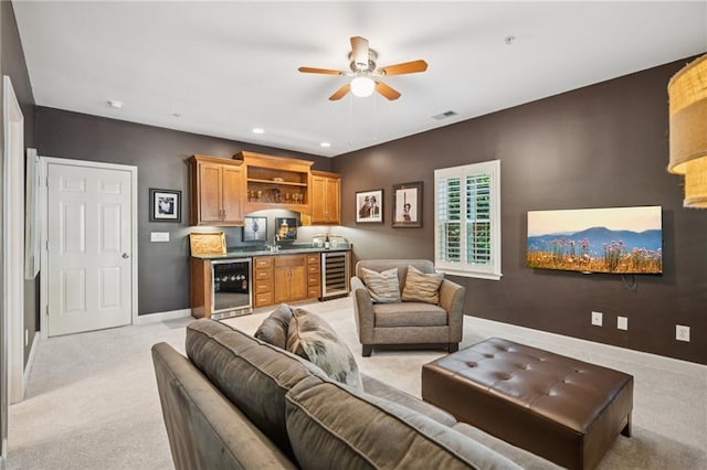 11259 Calypso Dr, Alpharetta, GA 30009 - living room with beverage cooler, bar with sink, light carpet, ceiling fan, and baseboards