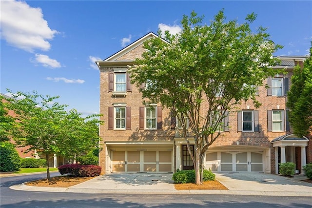 11259 Calypso Dr, Alpharetta, GA 30009 - view of front of property featuring an attached garage, driveway, and brick siding