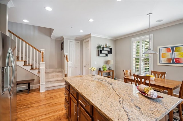 11259 Calypso Dr, Alpharetta, GA 30009 - kitchen with stainless steel fridge with ice dispenser, light wood-style flooring, ornamental molding, recessed lighting, and pendant lighting
