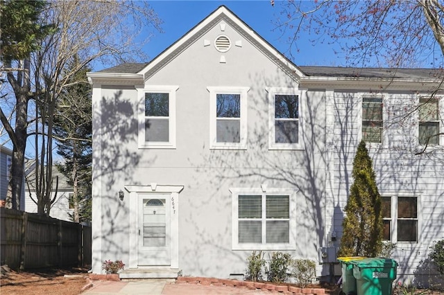 view of front of home featuring fence and stucco siding