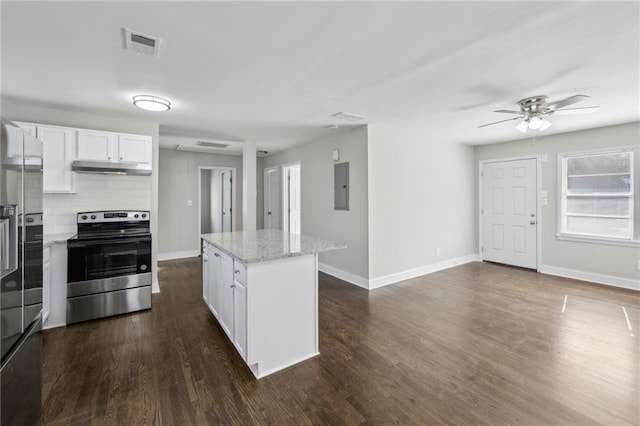 kitchen featuring a center island, white cabinetry, light stone countertops, stainless steel appliances, and dark hardwood / wood-style flooring