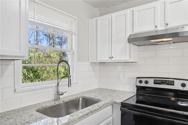 kitchen featuring electric stove, decorative backsplash, sink, and white cabinetry