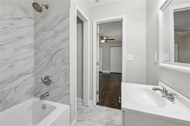 bathroom with vanity and tiled shower / bath