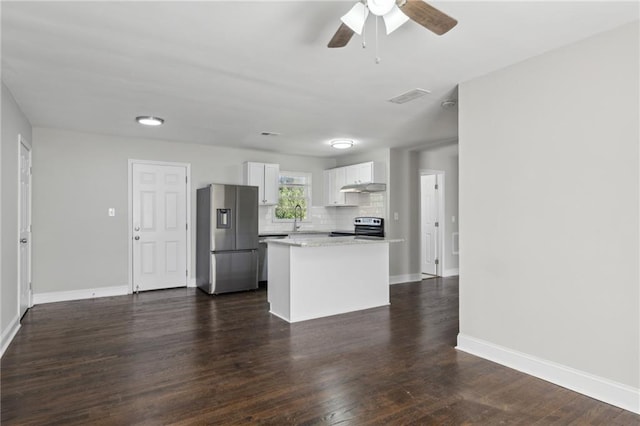 kitchen featuring white cabinets, dark wood-type flooring, stainless steel appliances, tasteful backsplash, and sink