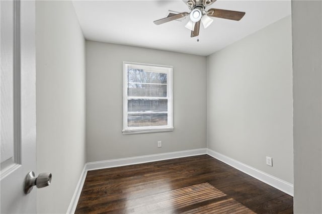 spare room with ceiling fan and dark hardwood / wood-style flooring