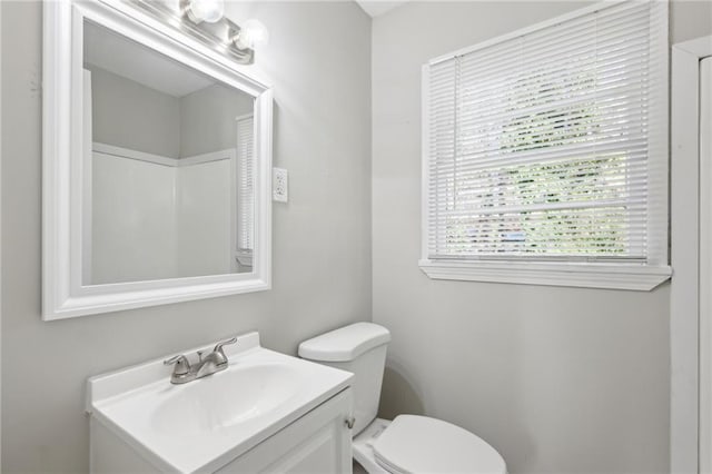 bathroom featuring toilet and vanity