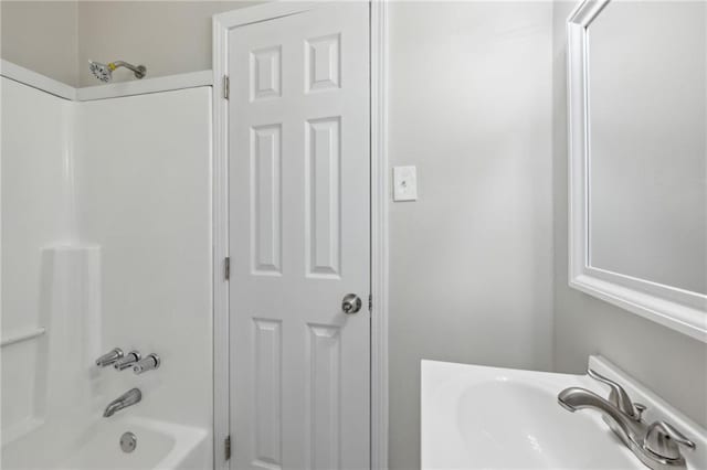 bathroom featuring  shower combination and sink