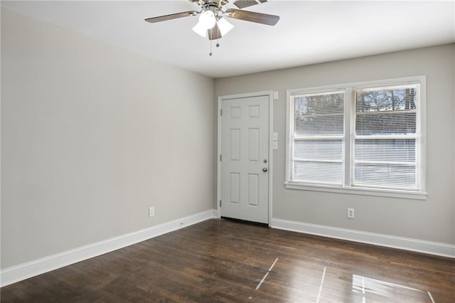 empty room with ceiling fan and dark hardwood / wood-style floors