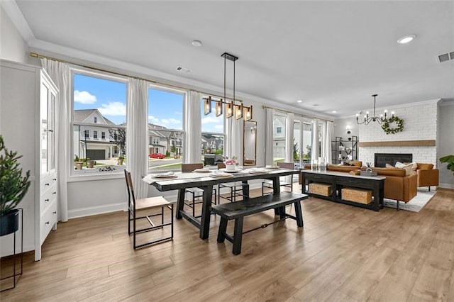 940 Emmett Walk, Alpharetta, GA 30004 - dining area with a chandelier, light wood-style flooring, ornamental molding, a fireplace, and recessed lighting