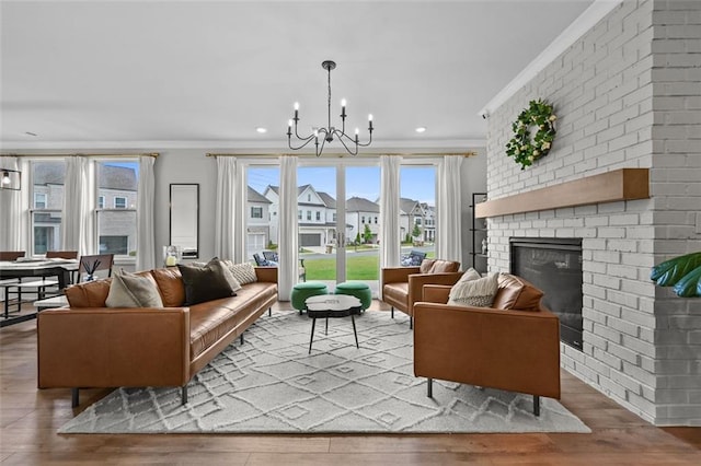 940 Emmett Walk, Alpharetta, GA 30004 - living room with a chandelier, wood finished floors, a fireplace, crown molding, and recessed lighting