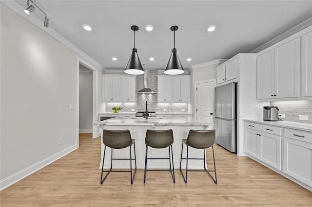 940 Emmett Walk, Alpharetta, GA 30004 - kitchen with stainless steel fridge, wall chimney exhaust hood, decorative backsplash, a breakfast bar, and recessed lighting