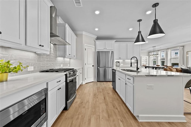 940 Emmett Walk, Alpharetta, GA 30004 - kitchen with stainless steel appliances, wall chimney exhaust hood, white cabinets, light wood finished floors, and recessed lighting