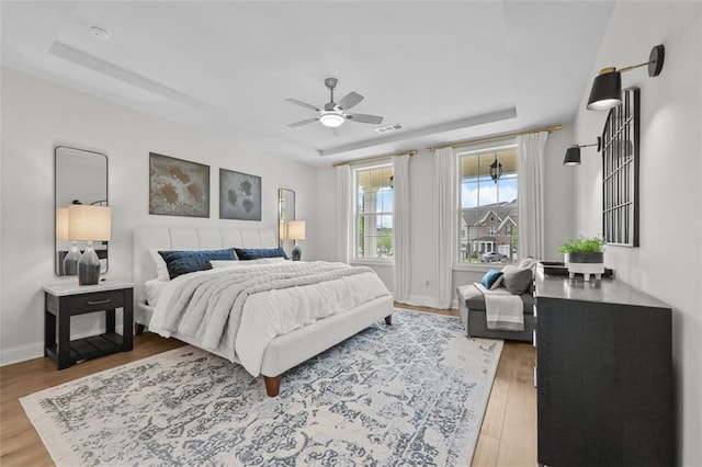 940 Emmett Walk, Alpharetta, GA 30004 - bedroom with a tray ceiling, wood finished floors, and a ceiling fan
