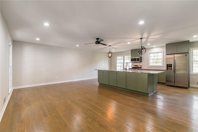 2146 Chevy Chase Ln, Decatur, GA 30032 - kitchen featuring stainless steel appliances, green cabinets, recessed lighting, a center island, and dark wood-style flooring