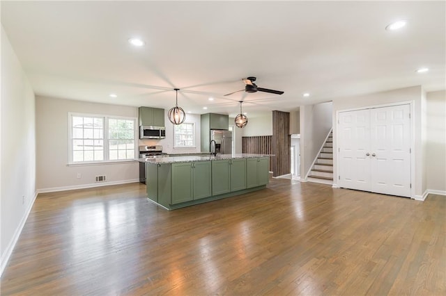 2146 Chevy Chase Ln, Decatur, GA 30032 - kitchen featuring green cabinets, appliances with stainless steel finishes, recessed lighting, an island with sink, and dark wood finished floors