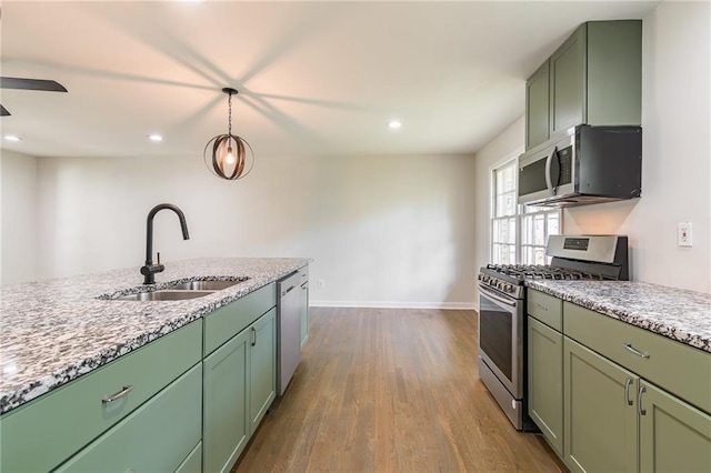 2146 Chevy Chase Ln, Decatur, GA 30032 - kitchen featuring appliances with stainless steel finishes, a sink, green cabinets, dark wood finished floors, and recessed lighting