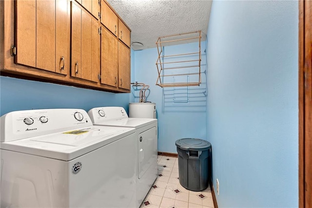 57 Fair Oaks Dr SE, Conyers, GA 30094 - washroom featuring cabinet space, separate washer and dryer, baseboards, a textured ceiling, and water heater