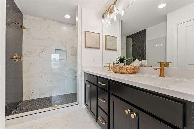 bathroom with marble finish floor, a sink, recessed lighting, a marble finish shower, and double vanity