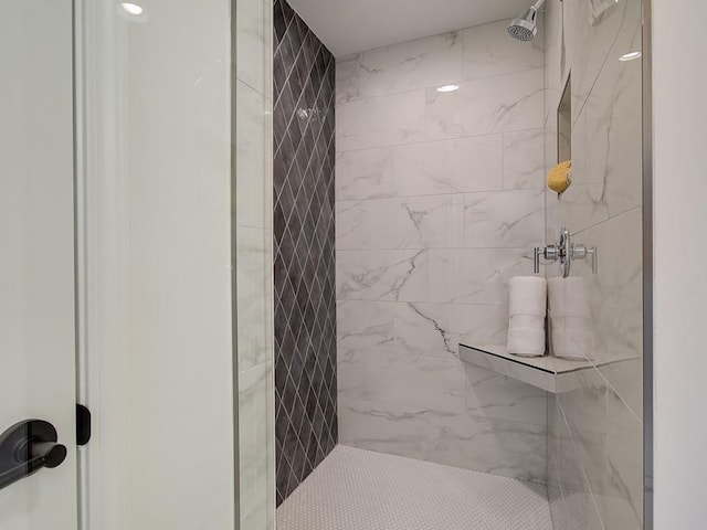 bathroom with a tile shower