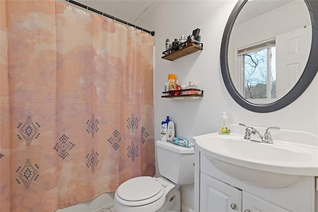 bathroom featuring toilet, a shower with shower curtain, and vanity