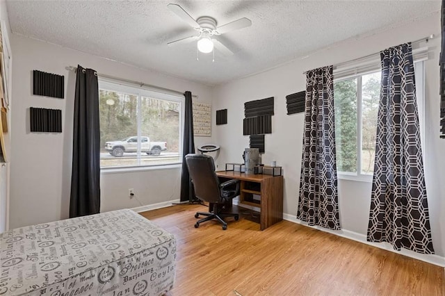 office with wood-type flooring, a textured ceiling, and ceiling fan