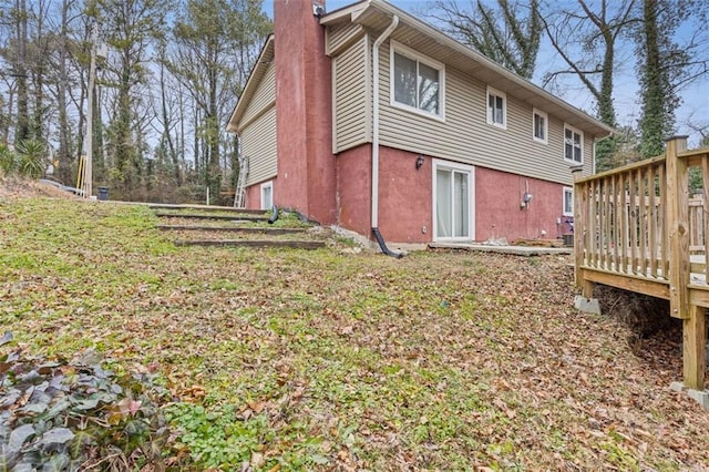 back of property with a wooden deck