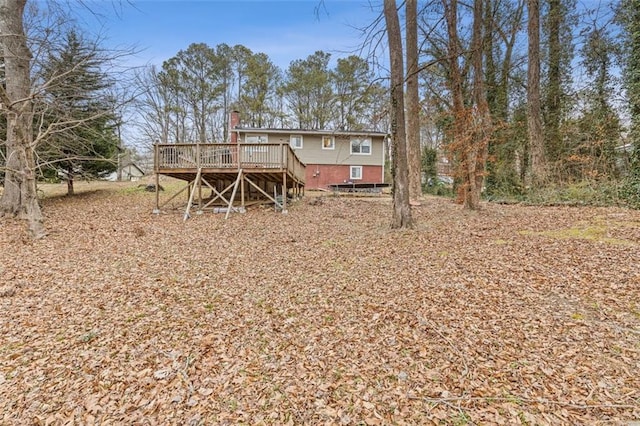 back of property with a wooden deck