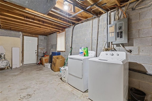 clothes washing area with electric panel and independent washer and dryer